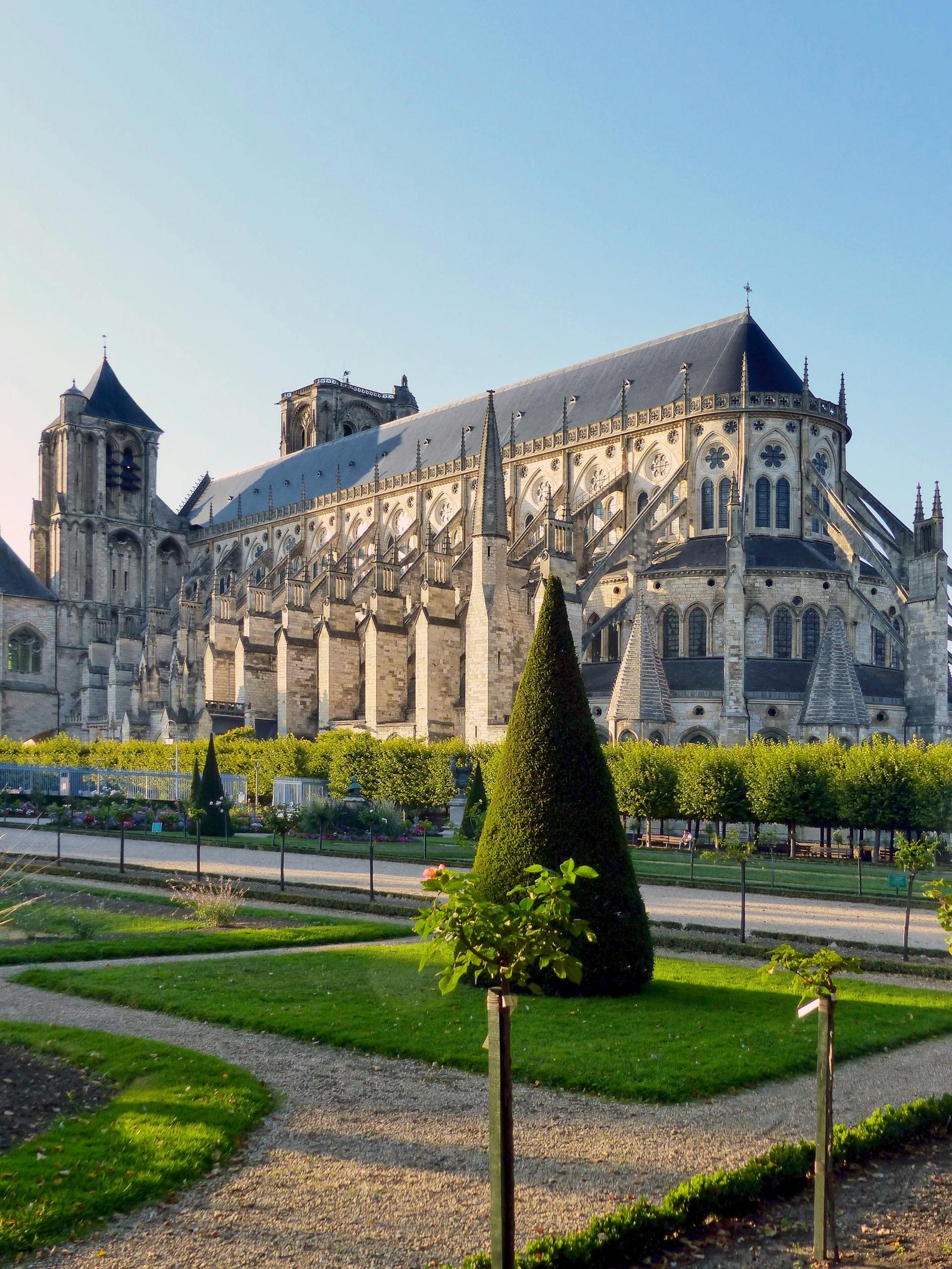 Stunning Gothic architecture of Bourges Cathedral surrounded by lush gardens in France.