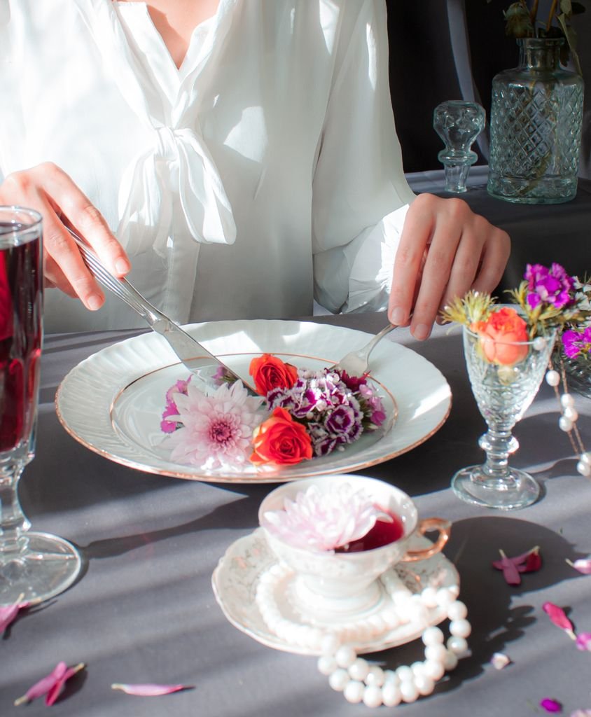 Elegant dining scene with flowers and tea. Aesthetic and sophisticated.