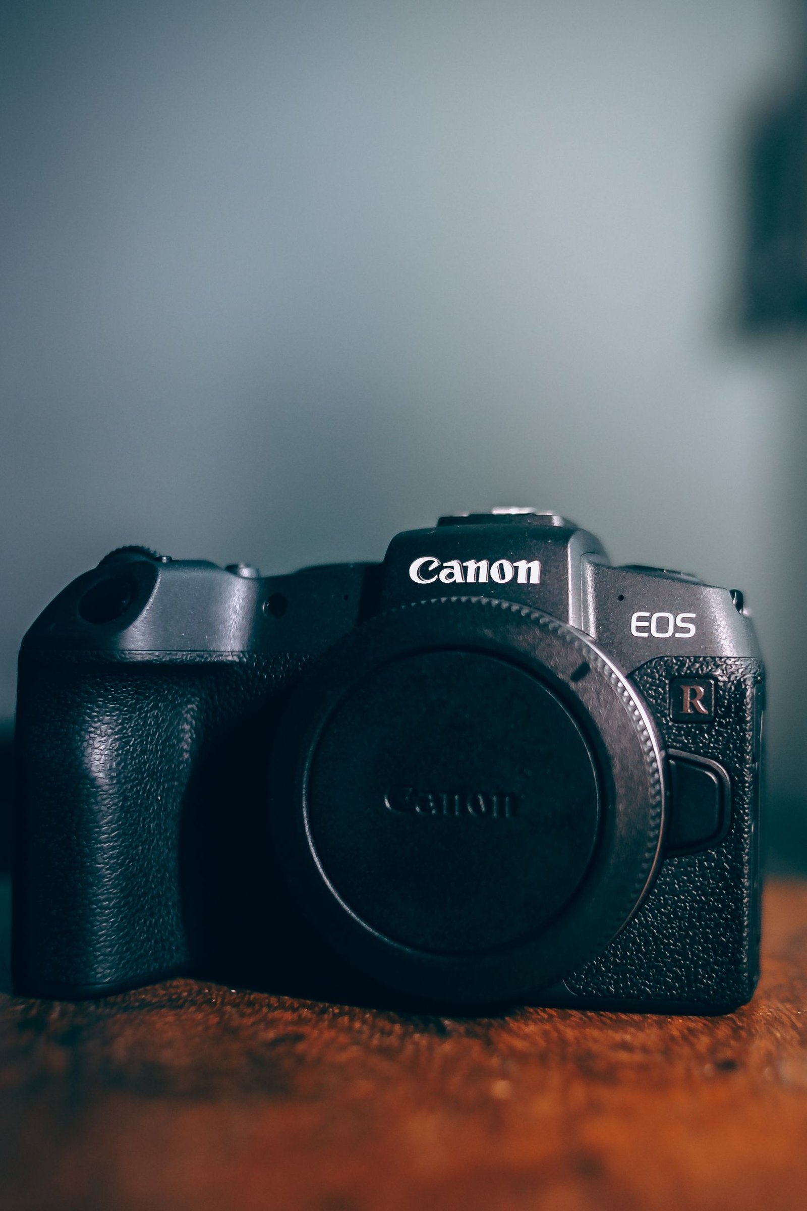 Professional digital camera displayed on a wooden table, ideal for photography enthusiasts.