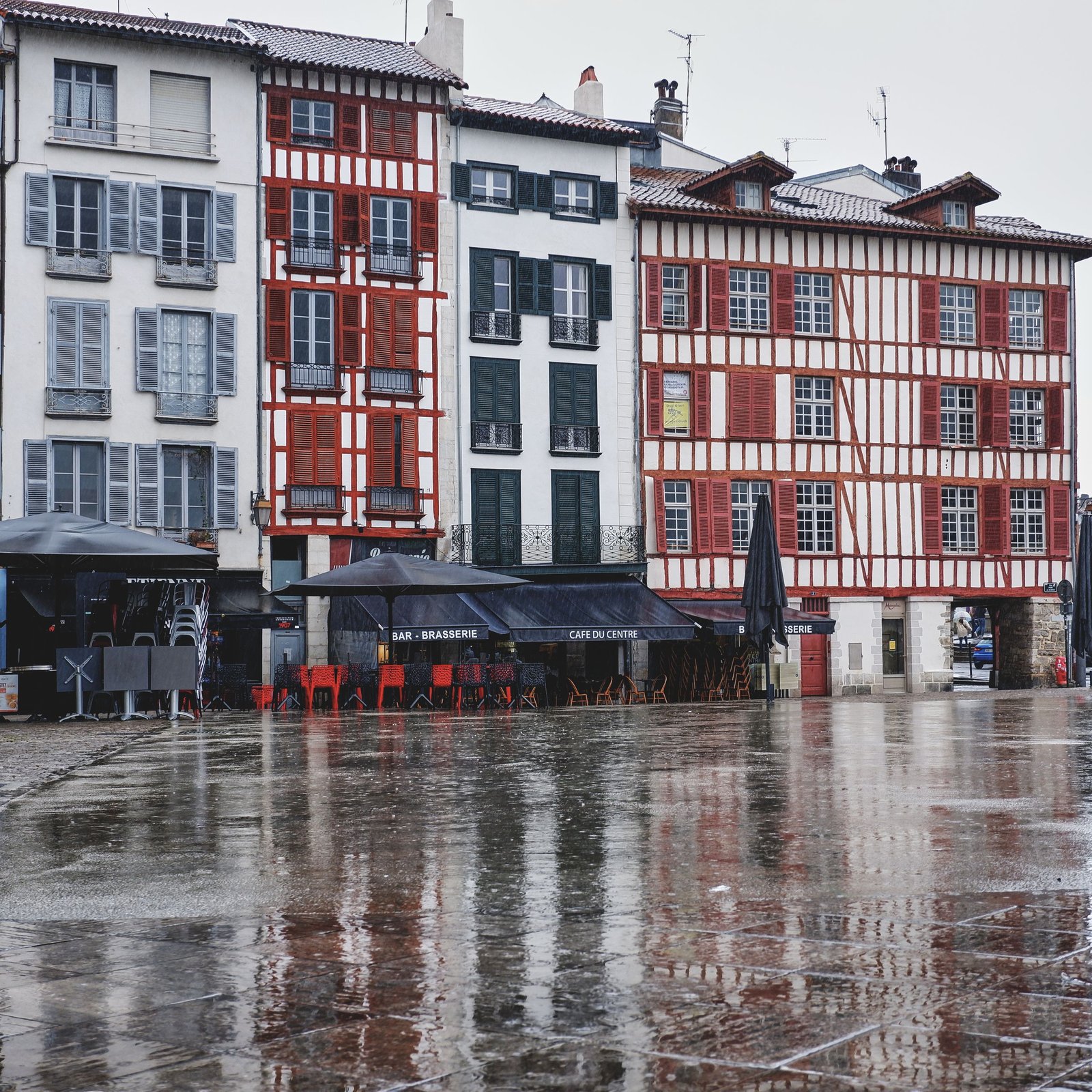 Rain-soaked streets enhance the charm of Bayonne's historic architecture.